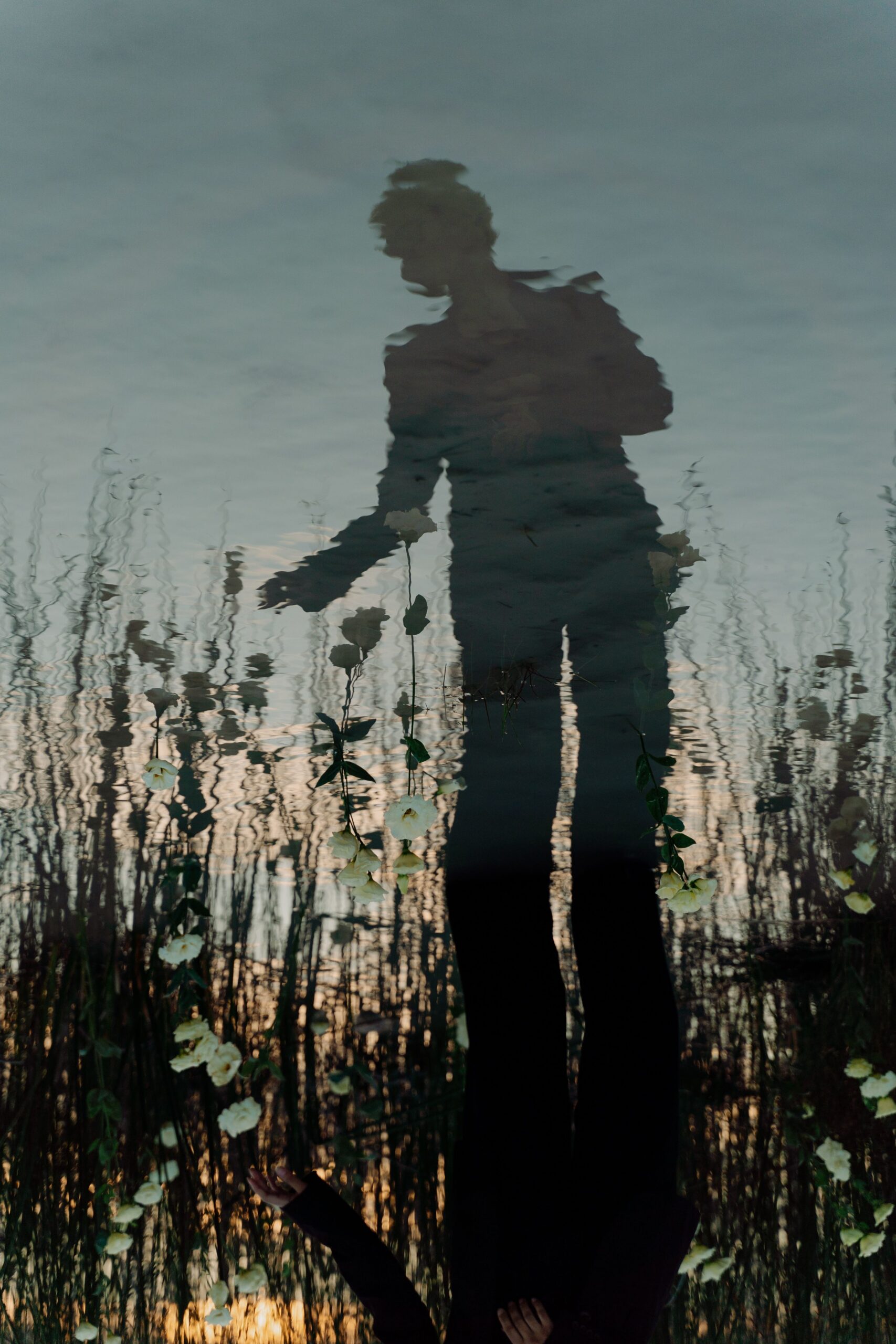 Photo of sillhoutte shadow of a woman reflected in the water evocative of stripping away the identity of good girl or villain